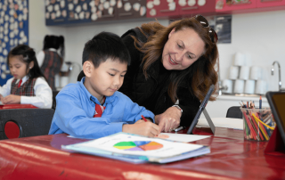 A photo of a teacher sharing a love of learning with a St Therese Catholic Primary School Sadleir Miller student
